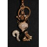 Porte clefs en métal argenté formant un renard noir tête couronnée.